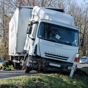 A truck involved in an accident veered off the road symbolizing a truck accident - Colton Holm