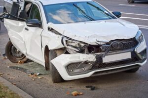 Car with severe damage, front-end and rear-end collision aftermath.