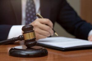 Hand of legal profession on papers, gavel
