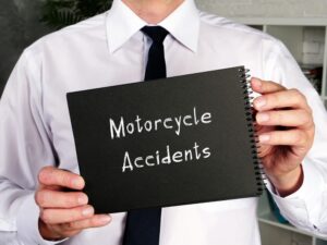 Motorcycle crash lawyer holding a paper written Motorcycle Accidents