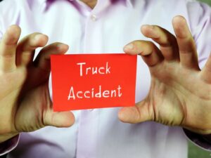 A person holding piece of paper text Truck Accident
