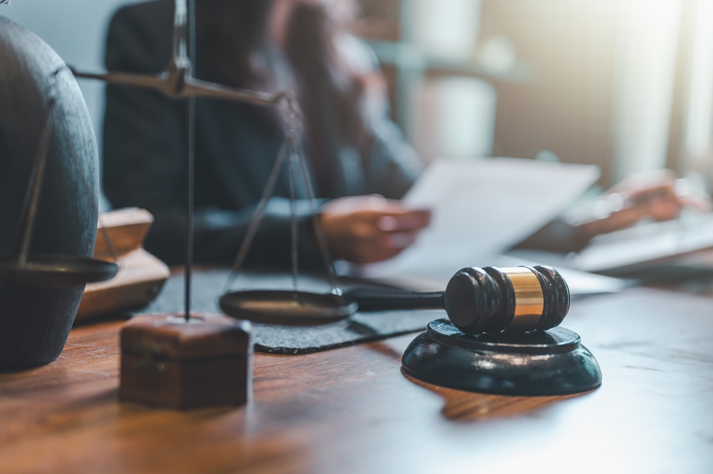 A gavel and scales of justice on a lawyer’s desk, symbolizing legal representation for survivors of sexual abuse in Billings, Montana.