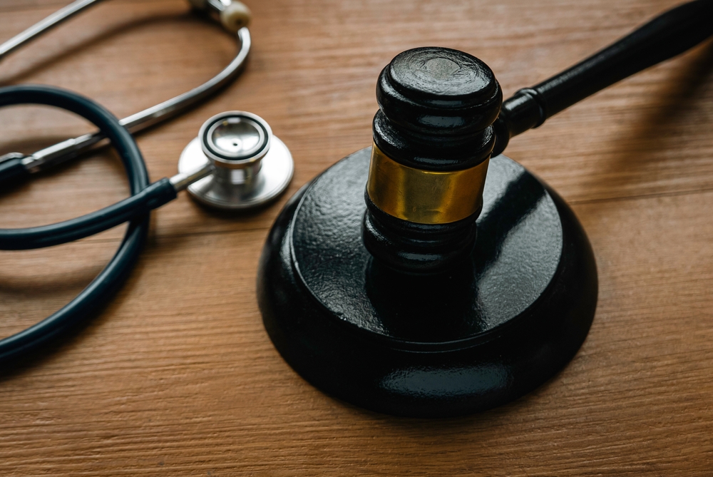 A judge’s gavel and stethoscope on a wooden desk, representing the connection between medical evidence and personal injury law in Montana.