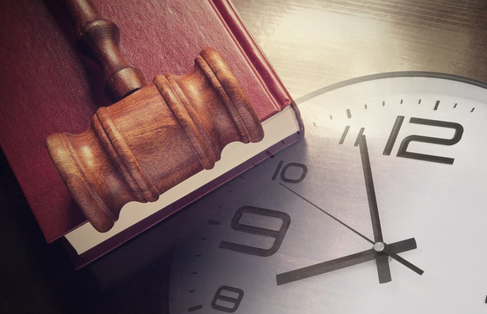 Clock, Gavel and Book on a table. 