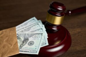 Judges Gavel and American dollar money on a wooden table 
