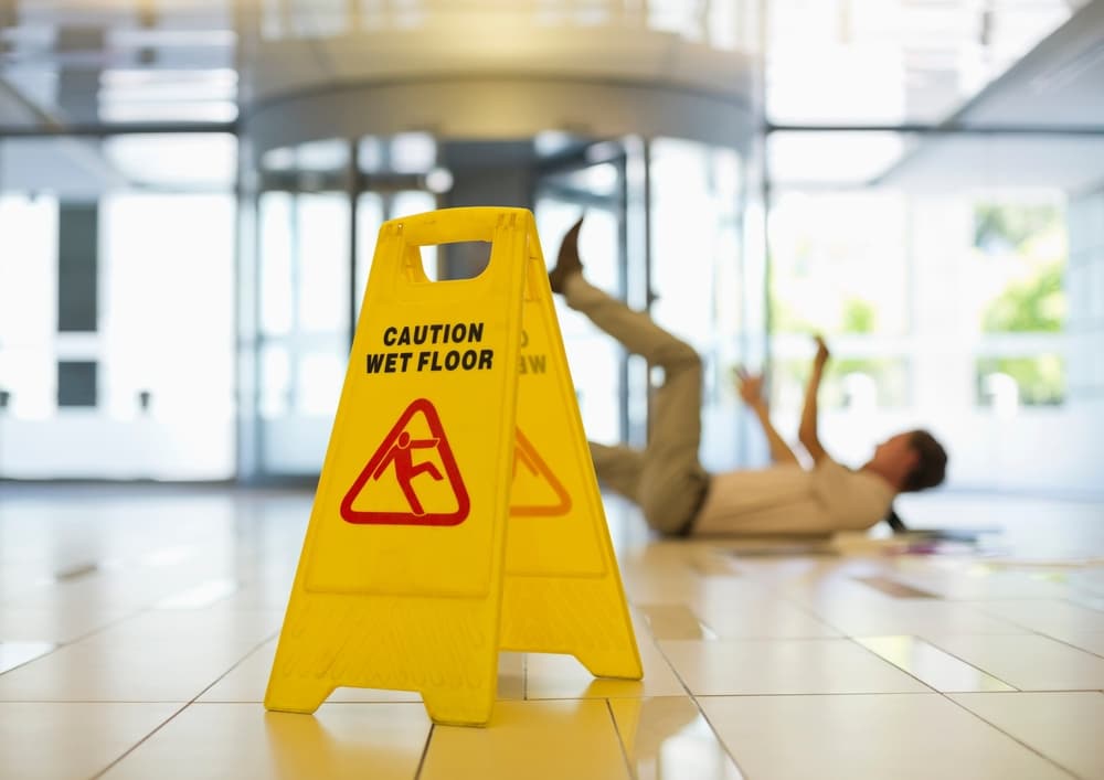 A man slipping on wet office floor